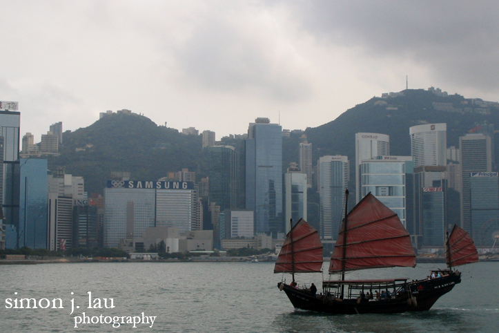 ship sailing in front of mid-levels between hong kong and kowloon