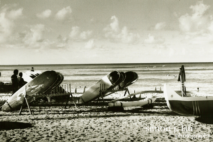 a photography of surfboards along waikiki